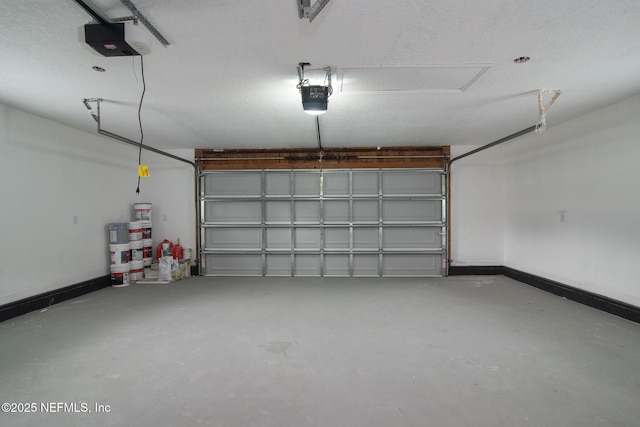 garage with a garage door opener and baseboards