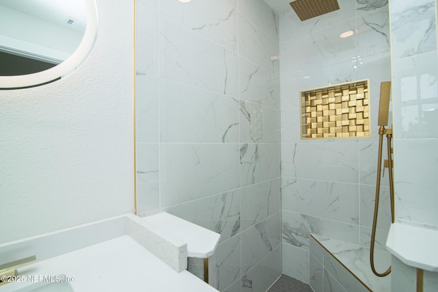 full bathroom with tiled shower