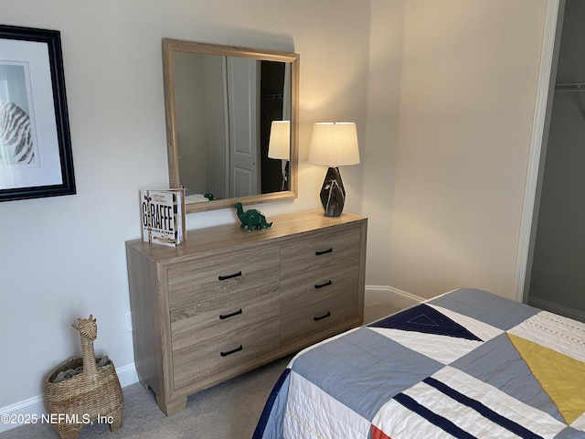 bedroom featuring dark carpet and baseboards