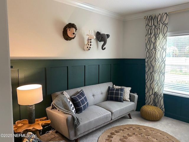 living area featuring carpet, crown molding, and wainscoting