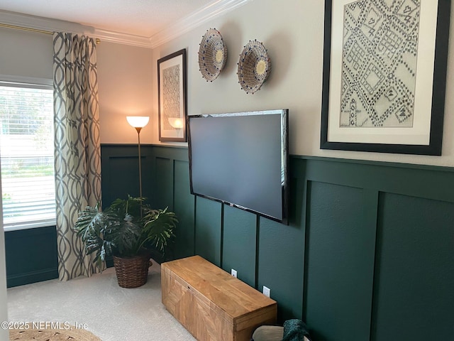 interior space with a wainscoted wall, carpet, a decorative wall, and crown molding