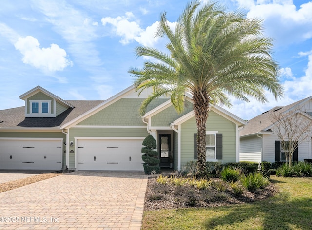 view of front of house featuring decorative driveway and an attached garage