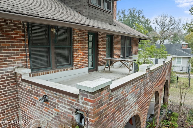 wooden terrace featuring fence