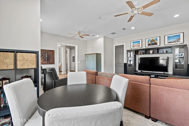 dining space with light carpet, visible vents, a ceiling fan, and recessed lighting