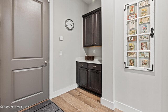 interior space featuring light wood finished floors and baseboards