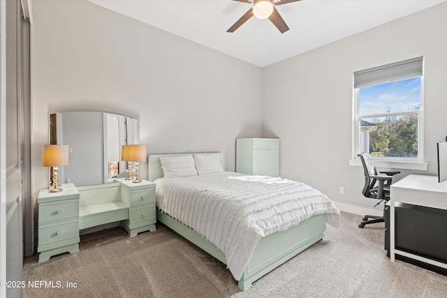 carpeted bedroom with ceiling fan and baseboards