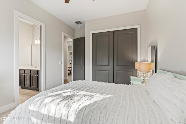 bedroom with connected bathroom, carpet floors, visible vents, baseboards, and a closet