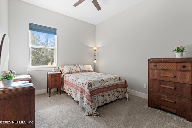 carpeted bedroom with baseboards and a ceiling fan