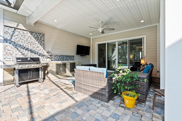 view of patio featuring an outdoor hangout area, ceiling fan, and an outdoor kitchen