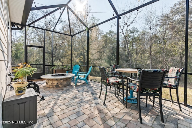 view of patio / terrace with a lanai and an outdoor fire pit