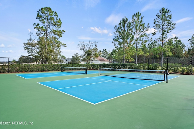 view of tennis court featuring fence