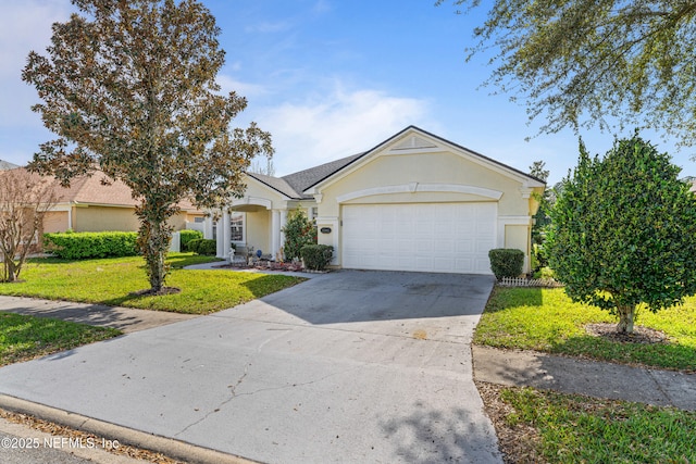 view of front of property featuring a garage, concrete driveway, a front lawn, and stucco siding