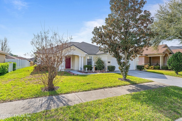 ranch-style house featuring stucco siding, a front yard, fence, a garage, and driveway