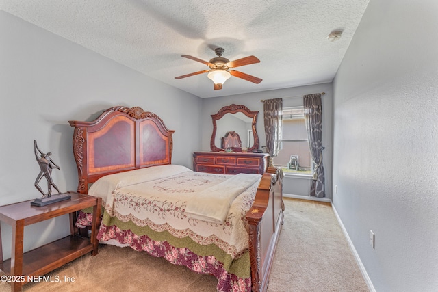 bedroom with carpet floors, ceiling fan, baseboards, and a textured ceiling