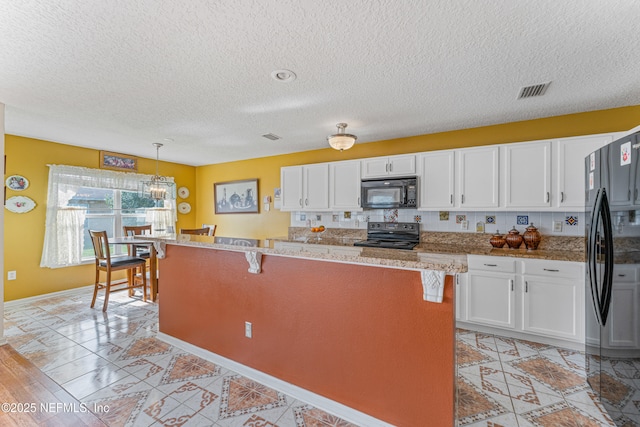 kitchen featuring a breakfast bar area, hanging light fixtures, backsplash, white cabinets, and black appliances