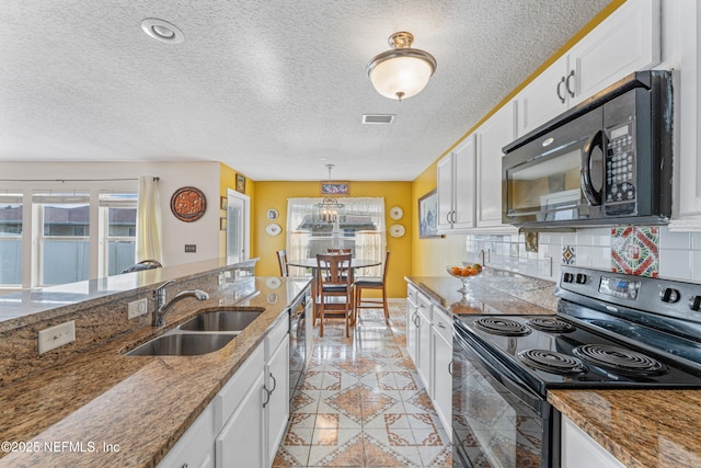 kitchen featuring tasteful backsplash, visible vents, white cabinets, black appliances, and a sink