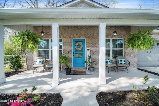 entrance to property with brick siding and covered porch