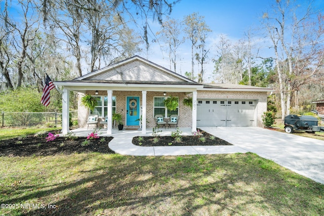 view of front of property with fence, a porch, concrete driveway, a garage, and brick siding