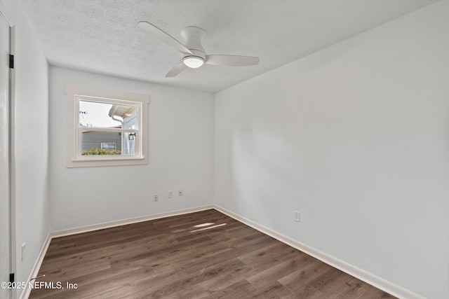 empty room featuring ceiling fan, a textured ceiling, baseboards, and wood finished floors