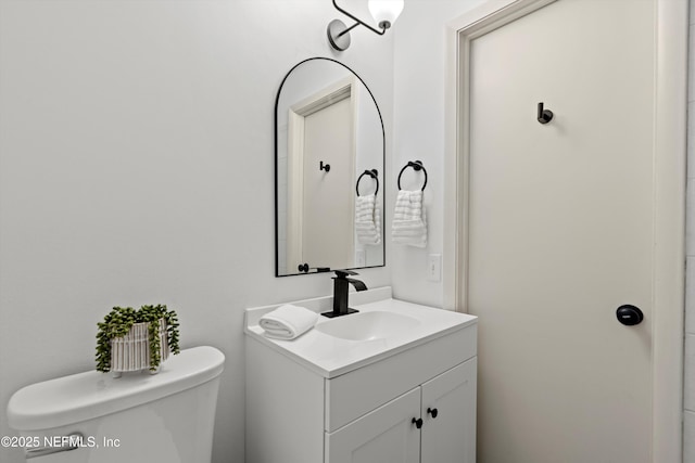 bathroom with toilet and vanity