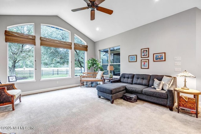 living area with high vaulted ceiling, recessed lighting, a ceiling fan, baseboards, and carpet