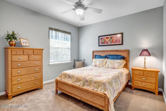 carpeted bedroom with a ceiling fan and baseboards