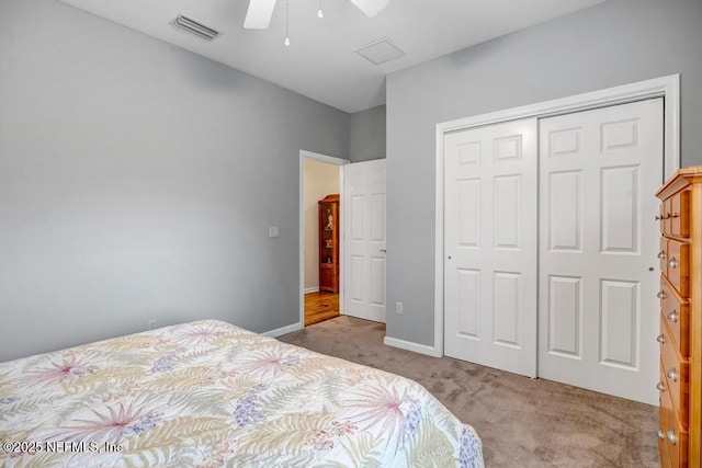 carpeted bedroom featuring a closet, visible vents, ceiling fan, and baseboards