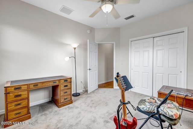 office area featuring light carpet, baseboards, visible vents, and a ceiling fan