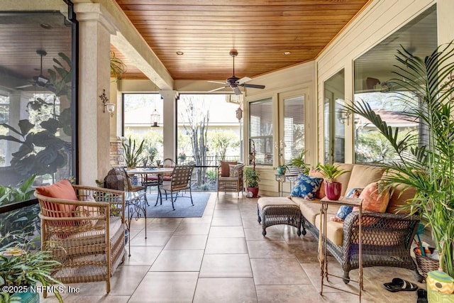 sunroom / solarium with wood ceiling and ceiling fan