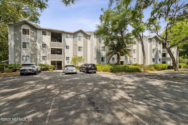 view of property featuring uncovered parking