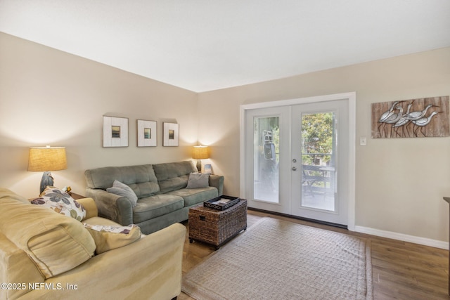 living room with baseboards, wood finished floors, and french doors