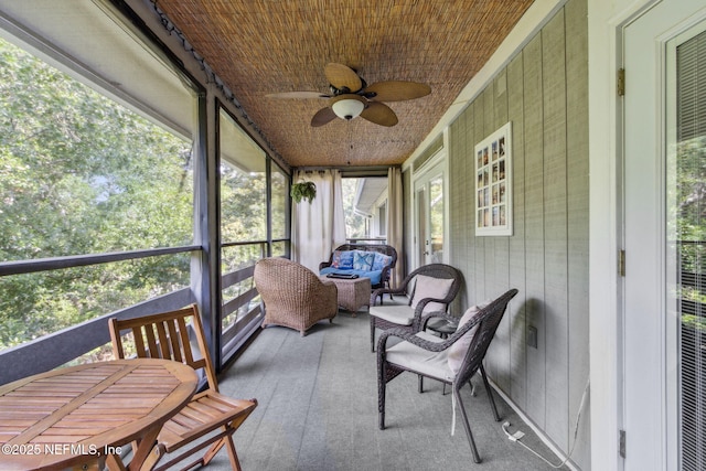 sunroom featuring a ceiling fan and a wealth of natural light