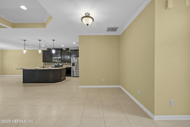 kitchen with crown molding, stainless steel appliances, tasteful backsplash, light countertops, and visible vents