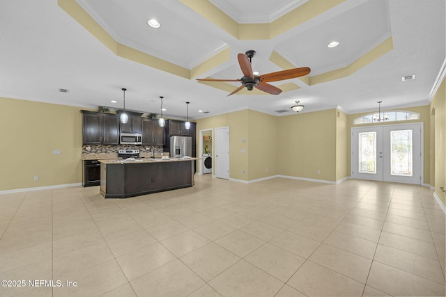 kitchen featuring appliances with stainless steel finishes, open floor plan, dark brown cabinetry, and light tile patterned floors