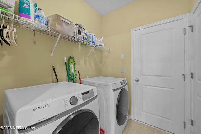 washroom with light tile patterned floors, laundry area, and separate washer and dryer