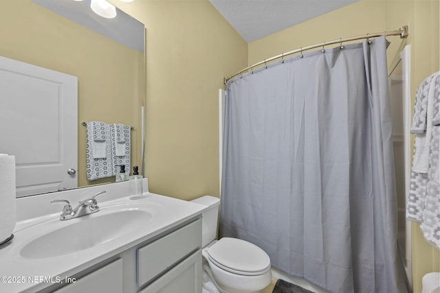 full bathroom featuring toilet, a textured ceiling, vanity, and a shower with curtain