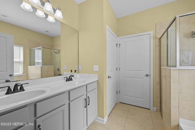 full bathroom featuring double vanity, tile patterned flooring, a shower stall, and a sink