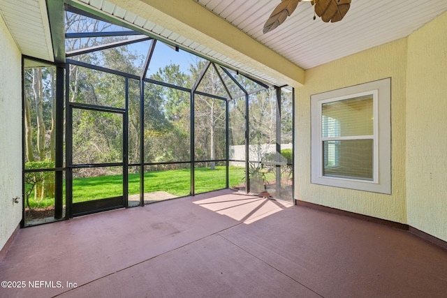 unfurnished sunroom featuring ceiling fan