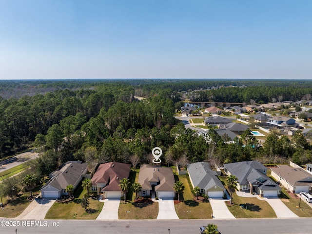 bird's eye view featuring a residential view and a forest view