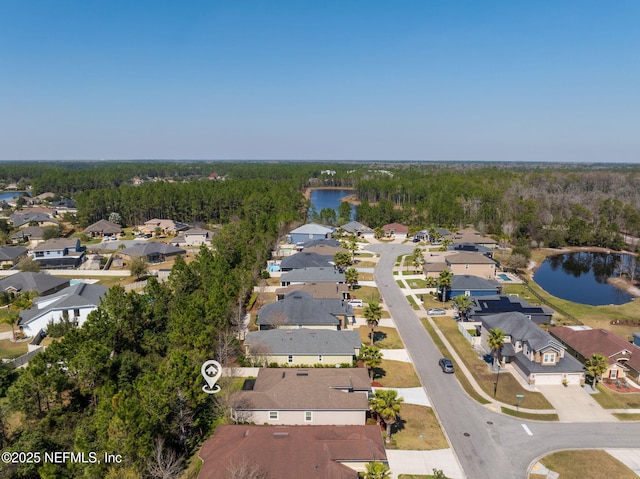 birds eye view of property with a residential view, a water view, and a forest view