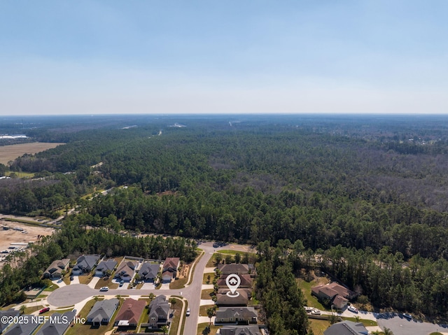 birds eye view of property with a residential view and a wooded view