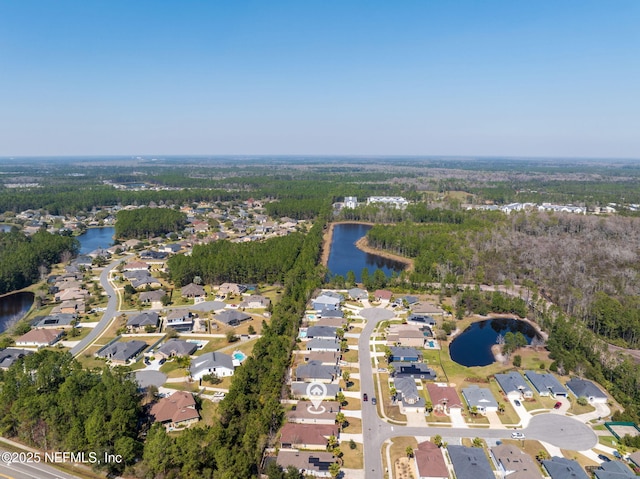 bird's eye view featuring a water view, a wooded view, and a residential view