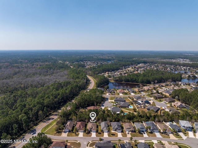 bird's eye view with a residential view, a water view, and a forest view