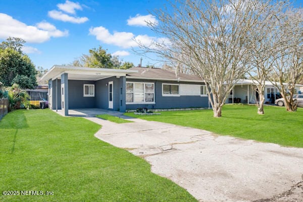 single story home featuring fence, an attached carport, concrete driveway, and a front yard