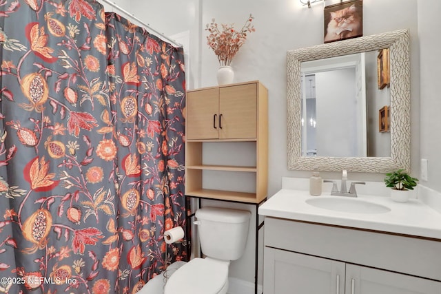 bathroom featuring vanity, toilet, and a shower with curtain