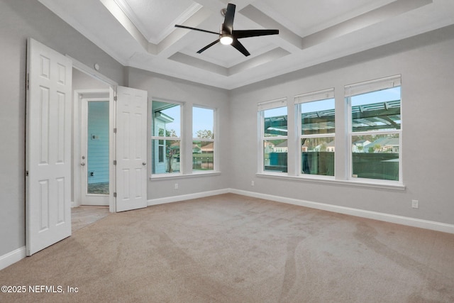 carpeted spare room featuring baseboards, coffered ceiling, a ceiling fan, crown molding, and beam ceiling