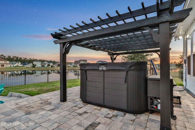 view of patio / terrace with a water view, fence, and a pergola