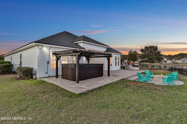 back of house with a patio, a lawn, a hot tub, a pergola, and a fire pit