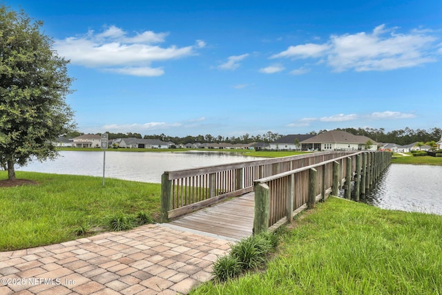 view of dock featuring a water view and a residential view