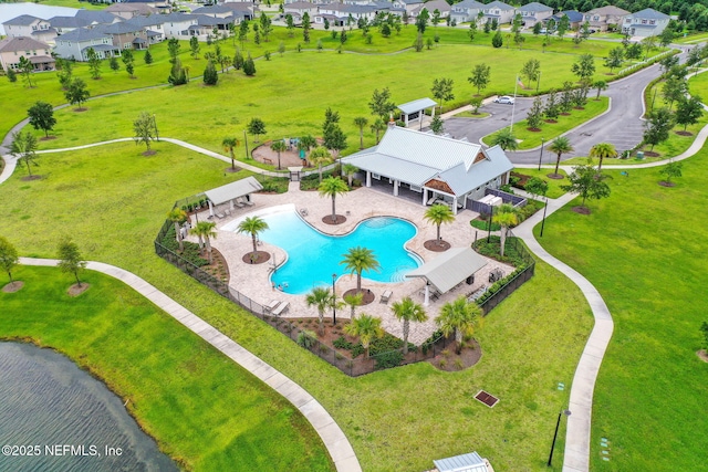 birds eye view of property with a water view and a residential view